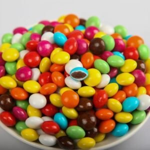 Macro shot of vibrant rainbow chocolate beans showing the smooth, crunchy sugar shell.